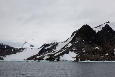 Scenic view of snow covered mountain against sky