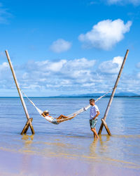 Couple enjoying by hammock at beach