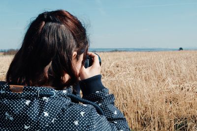 Rear view portrait of woman against sky