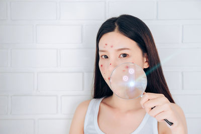 Portrait of a beautiful woman holding bubbles