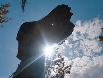 Low angle view of statue against sky during winter