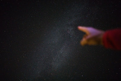 Person against star field at night