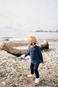 Side view of boy standing on beach