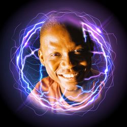 Portrait of smiling man against black background