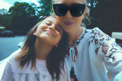 Portrait of young woman wearing sunglasses outdoors