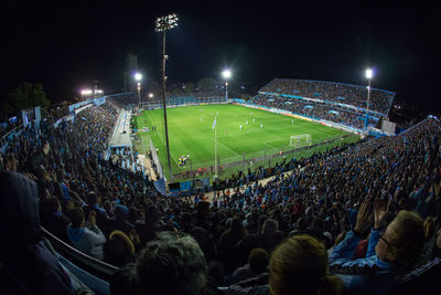 Group of people in soccer field at night