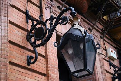 Low angle view of electric lamp on wall