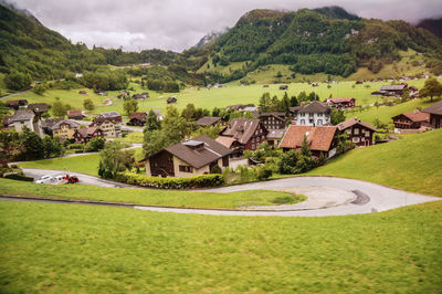 High angle view of houses by mountains against sky