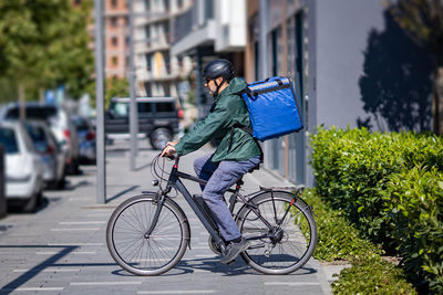 Delivery person riding electric bicycle