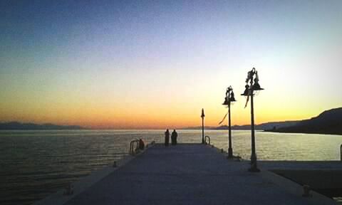 Silhouette person on beach against clear sky during sunset