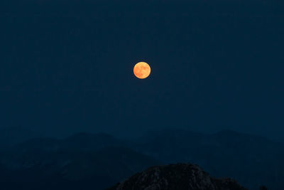 Scenic view of mountains against clear sky at night