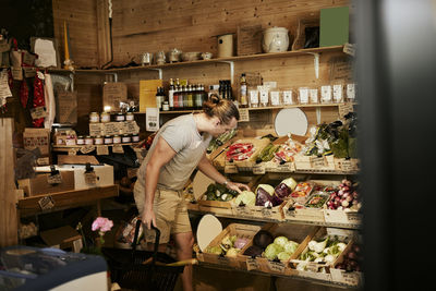 Man doing shopping in shop with organic food