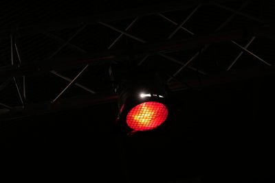 Low angle view of illuminated pendant lights hanging from ceiling