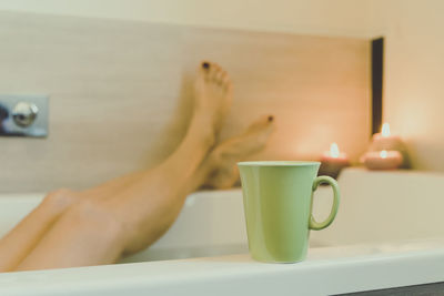 Low section of woman relaxing in bathtub 