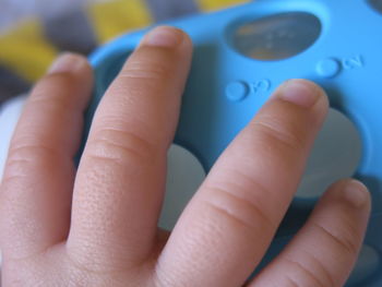 Cropped hand of baby touching toy
