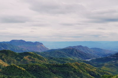 Scenic view of mountains against cloudy sky