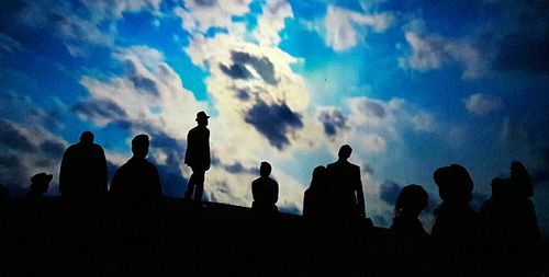 Low angle view of silhouette statues against sky