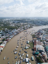 High angle view of townscape by sea against sky