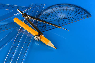 Low angle view of ferris wheel against blue sky