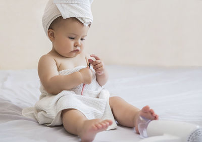 Portrait of cute baby boy sleeping on bed at home