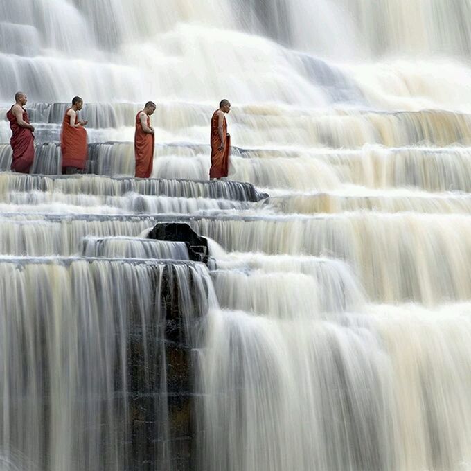 BLURRED MOTION OF MAN WITH WATERFALL