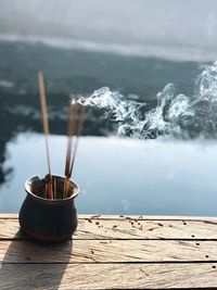 High angle view of incense sticks in container on table