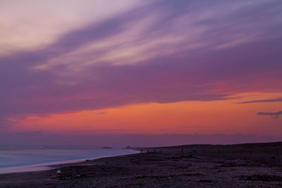 Scenic view of sea against romantic sky at sunset