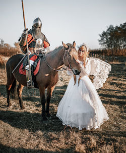 Horse riding horses in a field