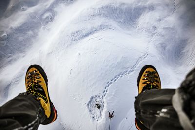 Low section of man sitting in ski lift