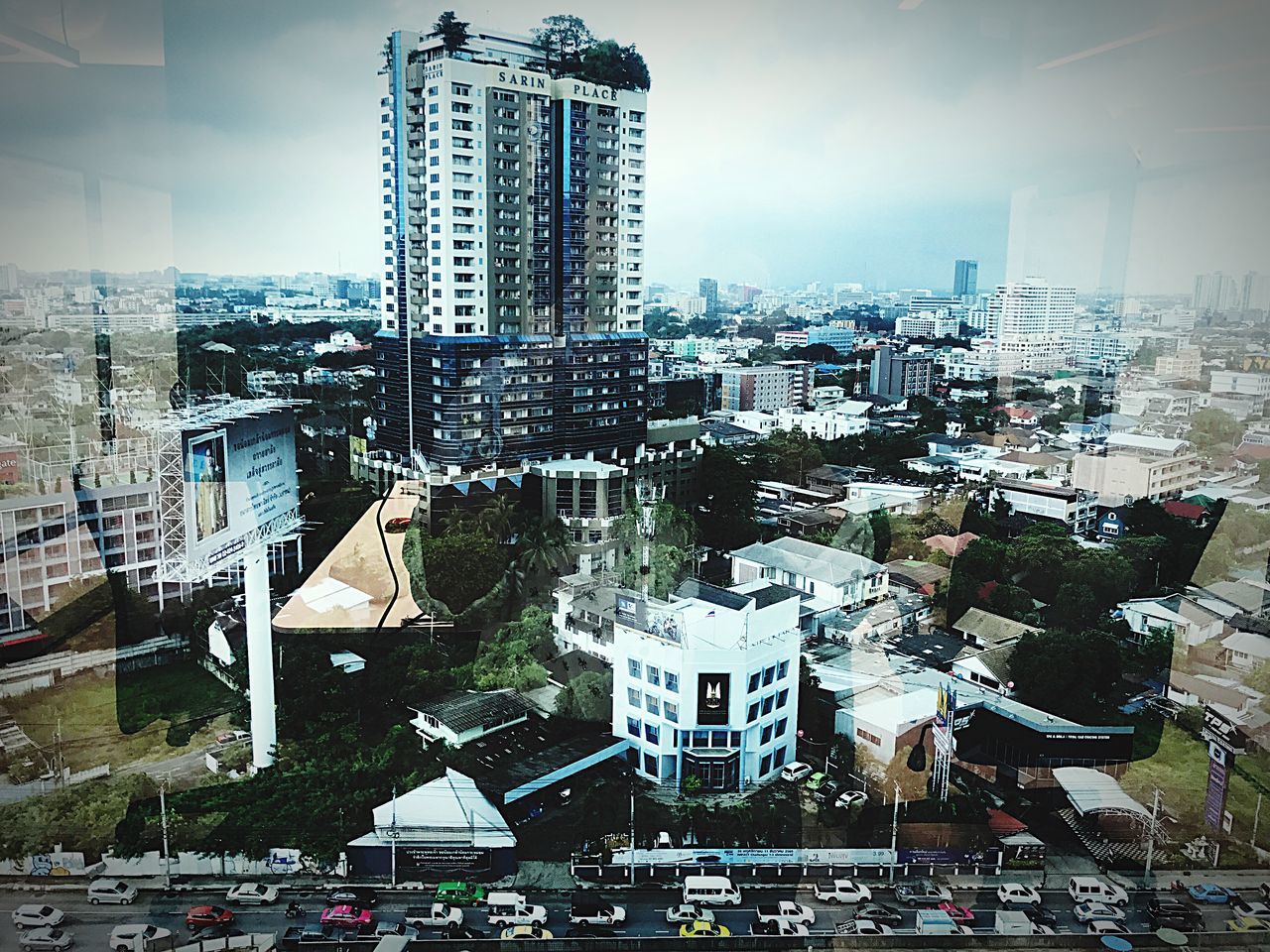 architecture, building exterior, city, skyscraper, built structure, tall - high, cityscape, tower, crowded, travel destinations, modern, outdoors, development, city life, day, tall, sky, urban skyline, road