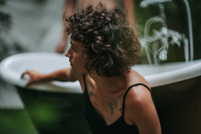 Side view of young woman in bathroom