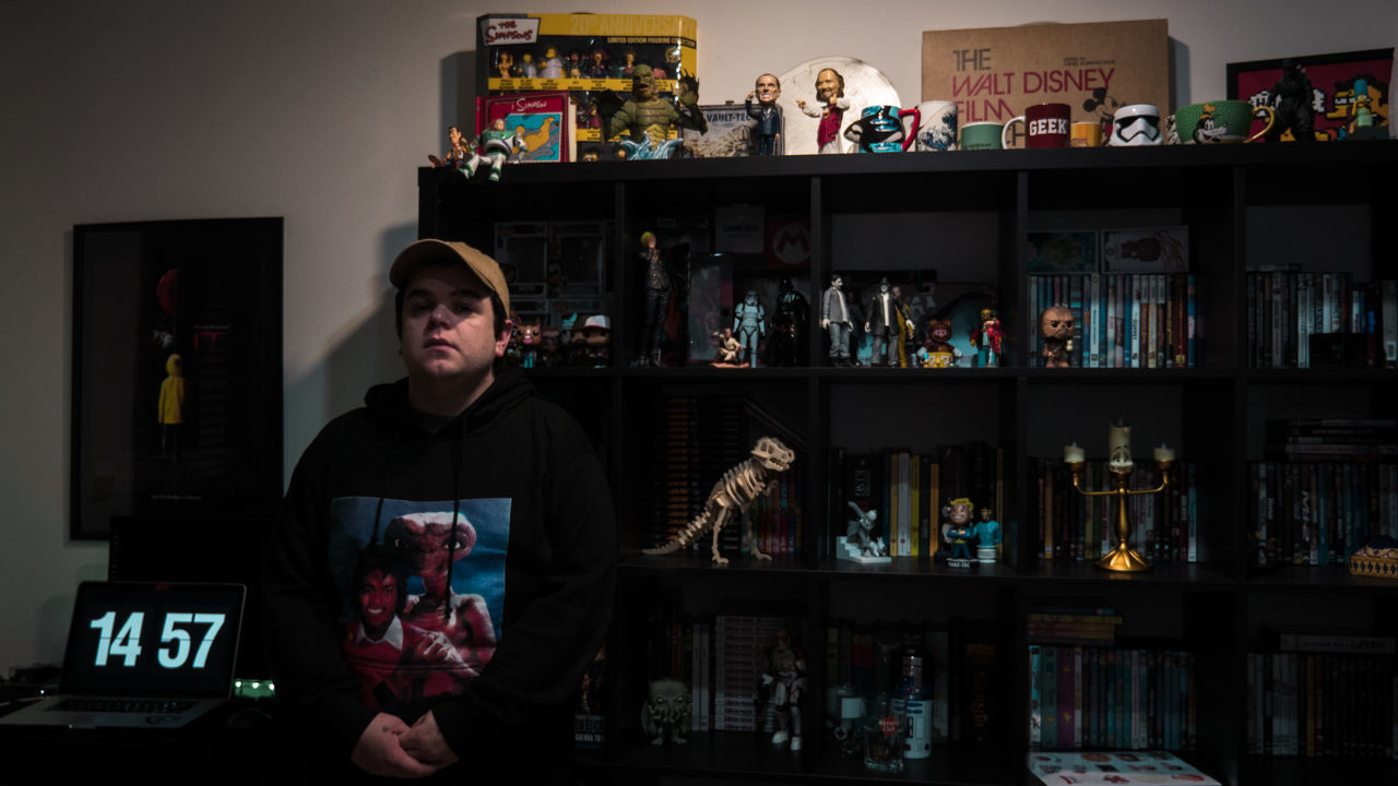 MAN STANDING IN SHELF