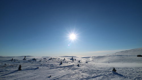 Scenic view of snow covered landscape against sky