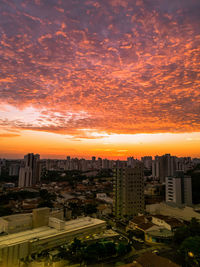 High angle view of buildings in city during sunset