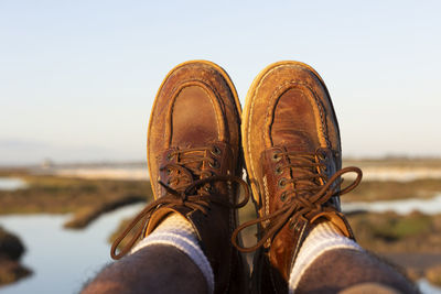 Man in boots enjoying wonderful views of the marshes with flamingos. freedom concept.