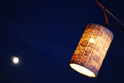 Low angle view of illuminated lights against sky at night