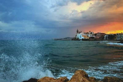 Scenic view of sea and buildings against sky