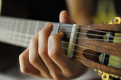 Close-up of hands playing guitar