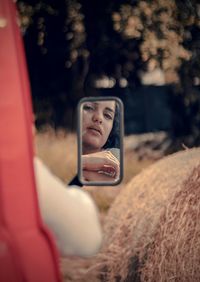 Reflection of woman in side-view mirror