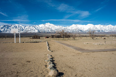 Scenic view of snowcapped mountains against blue sky