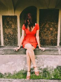 Full length of woman sitting outdoors
