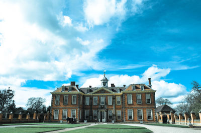 Built structure against blue sky and clouds