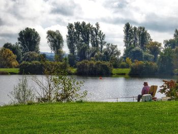 Scenic view of lake against cloudy sky