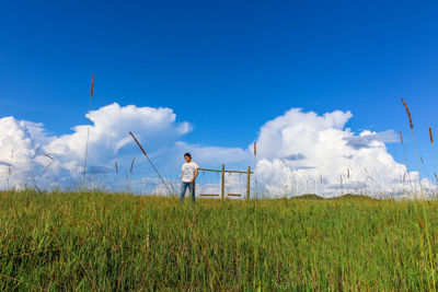 Man standing on field against sky