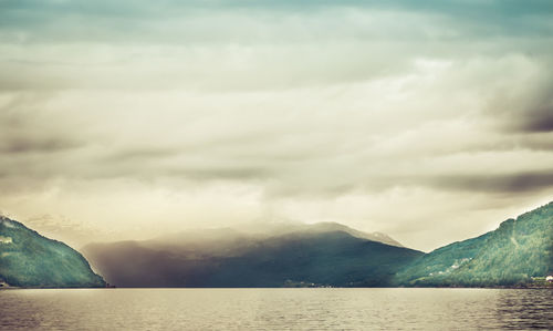 Scenic view of lake against cloudy sky