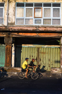Bicycles on street against building in city