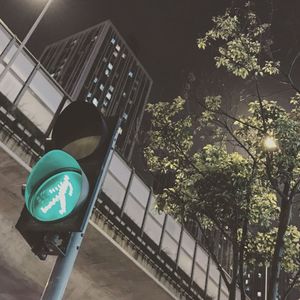 Low angle view of road sign against clear sky