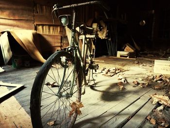 Bicycle parked on wooden wall