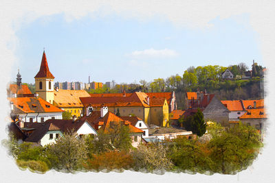 Buildings in town against sky