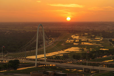 Aerial view of suspension bridge during sunset